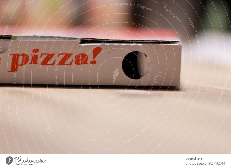 The word pizza is written on a box. Pizza box. delivery service, delivery service Cardboard pizza box to go Convenience order food Table Nutrition Dinner Lunch