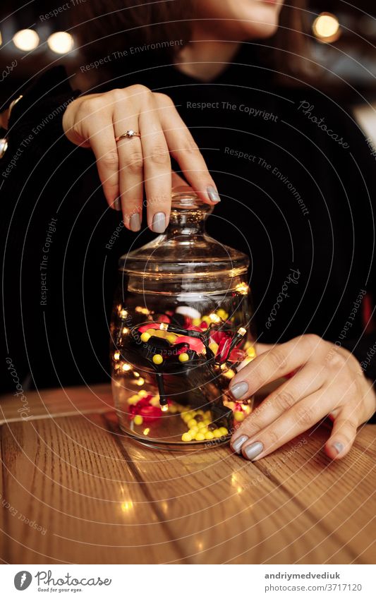 young woman showing bottle of medicine. colored capsules. Different medicinal capsule spill out of a glass. medicine concept pills background pharmacy