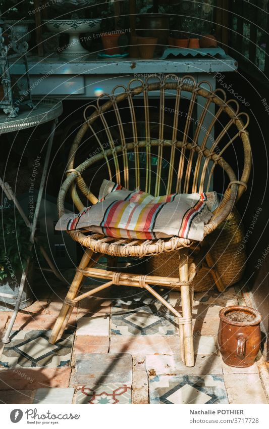 Rattan chair in the veranda with shadow and sun furniture seat rattan house vintage cushion old-fashion deco decorative style styling Furniture Chair Seating