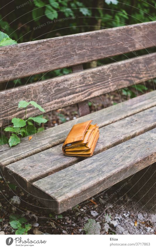 A lost wallet on a park bench Purse Doomed Forget left valuable Important found finder's reward Park bench object