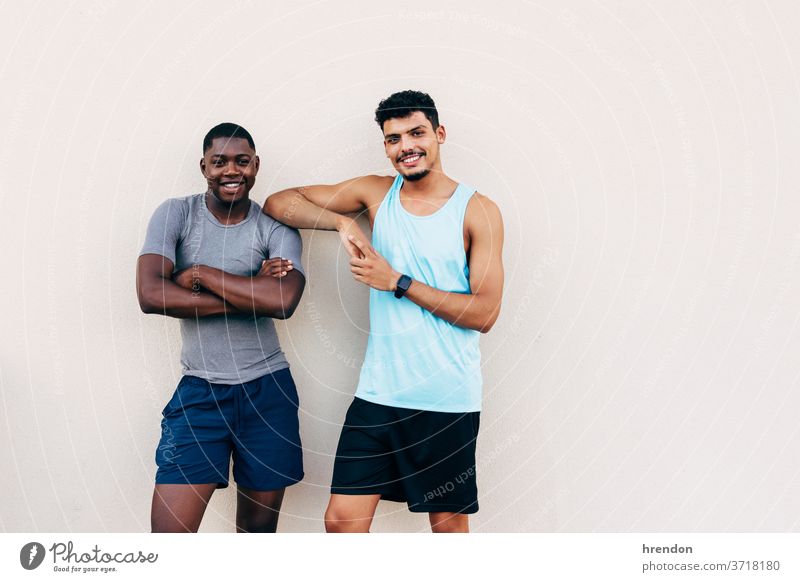 two young men dressed in sportswear man male athlete exercise fitness healthy lifestyle black handsome training together bodybuilding young adult two people