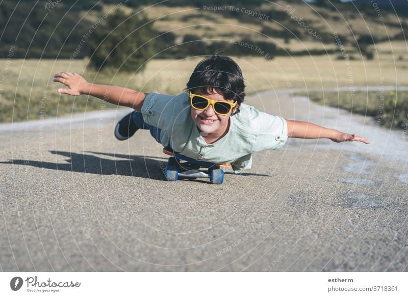 happy kid with skateboard and sunglasses on the road sport child travel childhood skater happiness skating activity lifestyle active city leisure urban smile