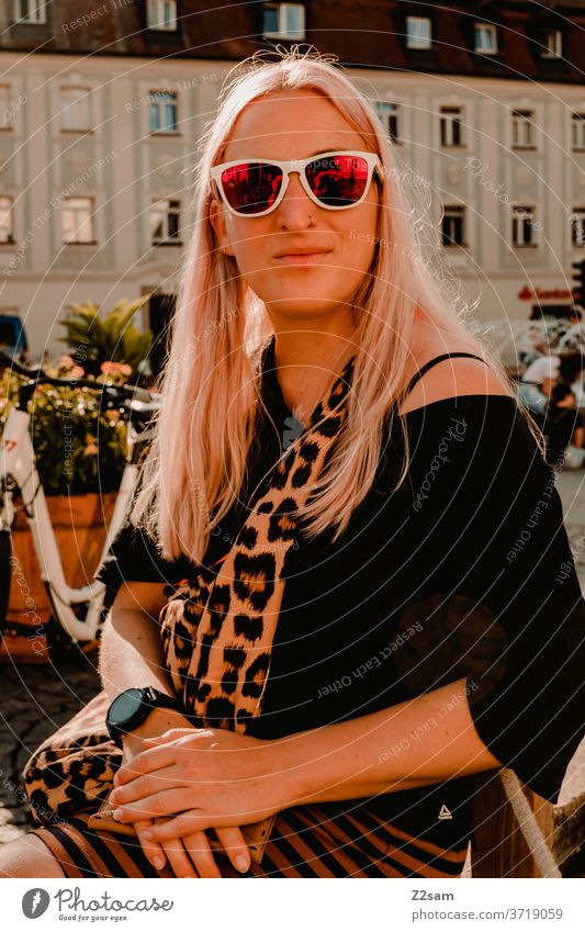Young woman in the city centre of Regensburg Bavaria Seeightsing Leopard print sunglasses Summer Sun Fashion fashion design Colour photo Human being already