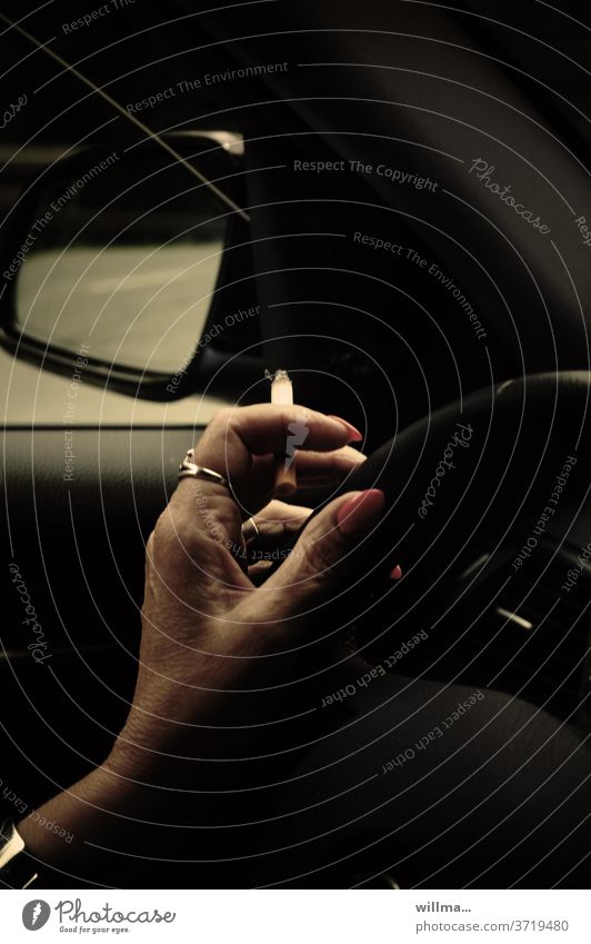 Driving nonchalance Smoking Motoring Hand Cigarette Driver Steering wheel car Car Concentrate distraction painted fingernails Vehicle Transport Woman negligent
