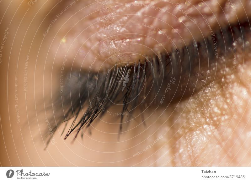 Macro shot of the human eyelid and eyelashes in. Daylight closeup closed skin person female adult beauty clean healthy macro conceptual cosmetic cry depression