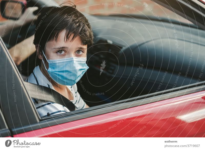 kid wearing medical mask riding in a car coronavirus motor vehicle seatbelts security safety epidemic pandemic quarantine child family covid-19 trip travel