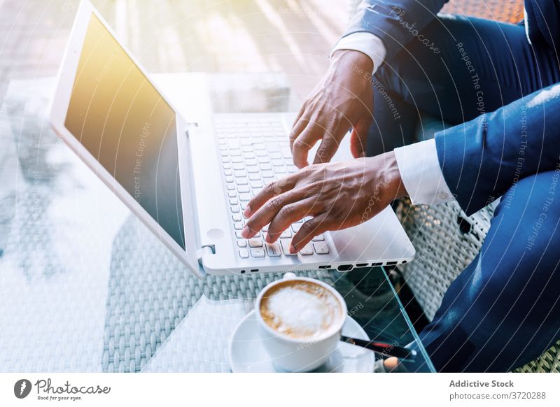 Businessman working on laptop in cafe businessman using busy formal typing browsing modern black african american ethnic coffee device gadget internet