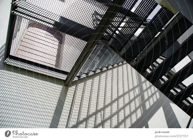 Emergency exit step by step Stairs Banister Landing Metal grid Stripe Line Shadow play Lanes & trails Diagonal Descent Structures and shapes Silhouette