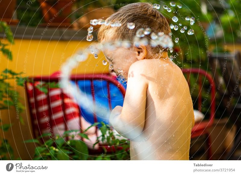 Boy gets splashed with water on the terrace and turns away Water Splash Inject Boy (child) Child Naked Skin Garden Balcony Terrace Paddling pool Garden Loop