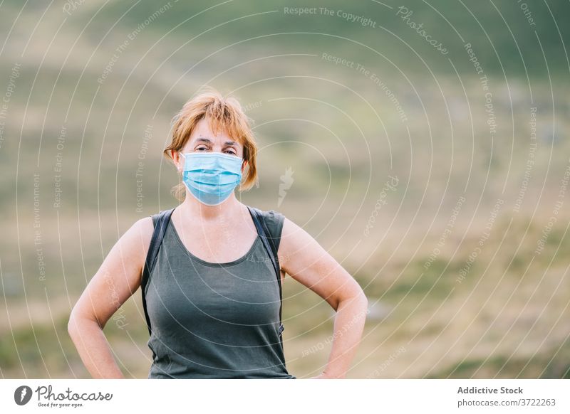 Traveling woman putting a medical face mask on her face journey prevent measure trip 50s safe explore pandemic prevention epidemic protect protective discovery