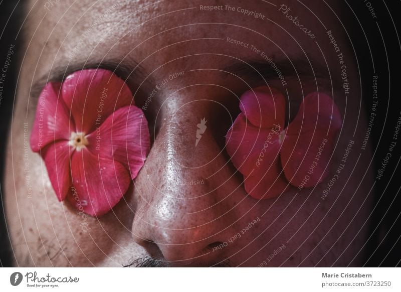 Conceptual portrait of a man with flowers covering his eyes face mysterious background mystery caucasian surrealism tranquility imagination mindfulness