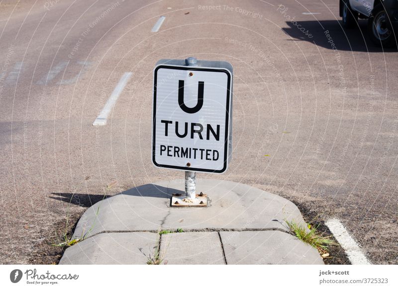 U-turn permitted Turnaround allowed hairpin bend Street Street refuge Asphalt Traffic infrastructure Road sign car shadow Lane markings Car Sunlight Calm Word