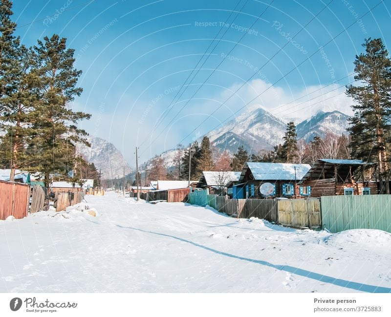 Village at the foot of the mountains in winter. Winter Snow Landscape countryside fresh air ecology healthy lifestyle tranquility old house wooden hut scenic