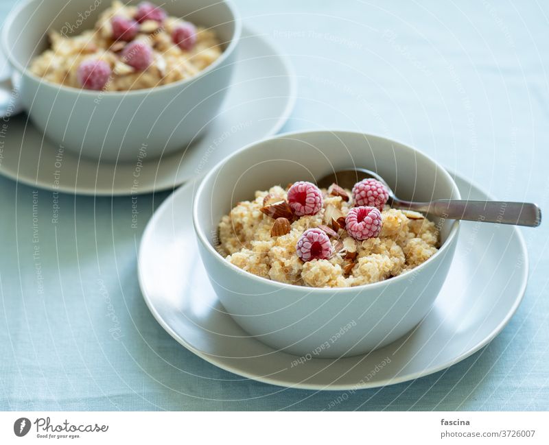 Quinoa porrige with raspberries and almond quinoa quinoa porrige breakfast porridge milk quinoa milk porrige meal morning nutrition overhead prepared protein