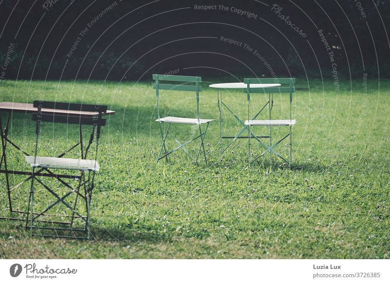 Summertime - Garden furniture on a green meadow in the sunshine, deserted in the early morning Outdoor furniture Meadow chairs Table Red Light Ease pretty