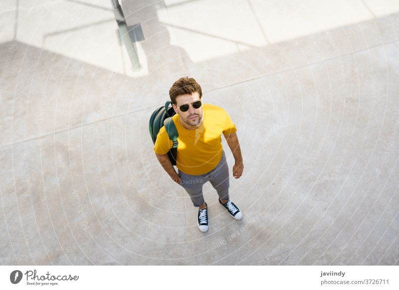 Top view of a male student on the university campus. man urban young backpack lifestyle person caucasian guy casual street background trendy stylish outside