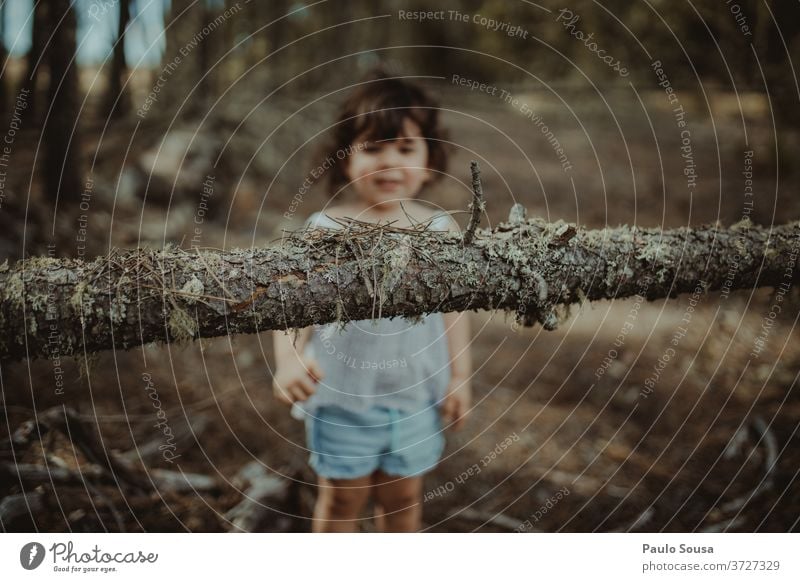 Little girl playing in the woods Child Children's game childhood Tree trunk Trunk having fun kids Toddler lifestyle Infancy Colour photo Playing happy