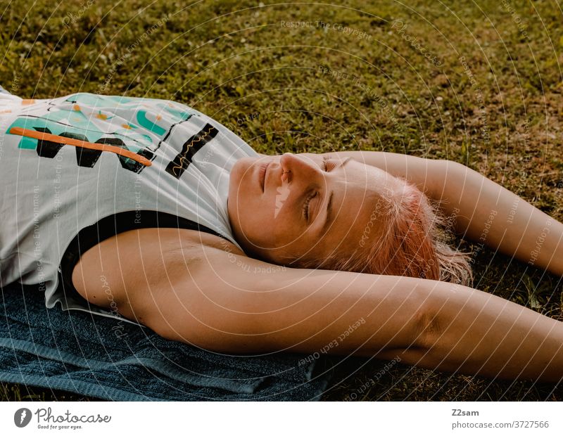 Young woman relaxing in the meadow relaxation Woman rest equalization Summer Sun Meadow Nature Lie Dream Sleep Relaxation youthful feminine Athletic yoga