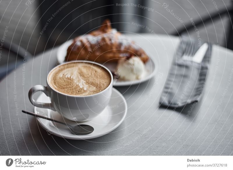 Cup of coffee and croissant on table in cafe breakfast coffee break drink morning cup espresso food bakery beverage brown caffeine fresh closeup hot wooden