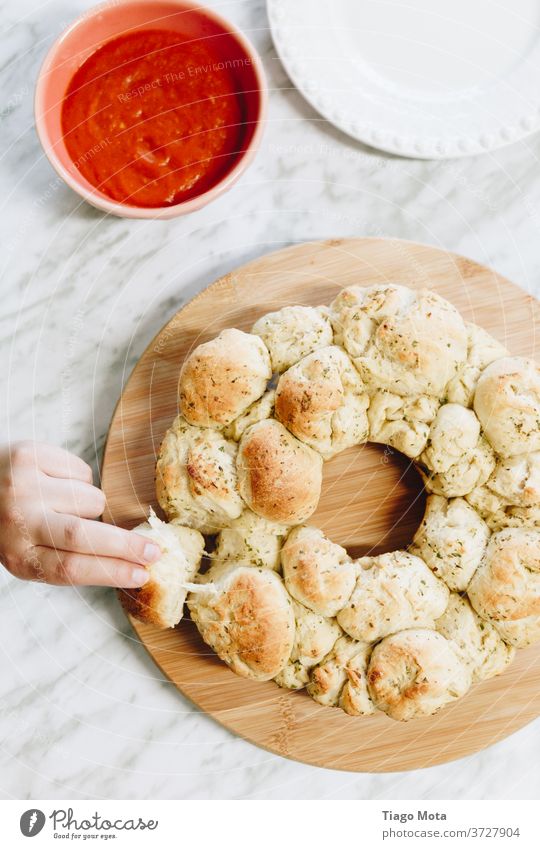 Hand Grabbing Delicious Garlic Bread Food Food photograph Food And Drink food products Food envy Food table food styling Food bowl Sauce garlic bread Vegetable