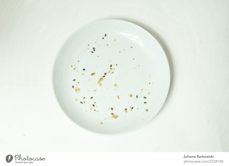 Empty plate with crumbs Plate Crockery White Nutrition Appetite Food Deserted Lunch Neutral Background Delicious world hunger Crumbs Eaten Pottery Interior shot