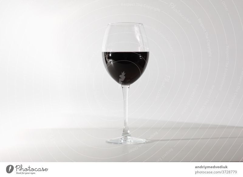 Glass of red wine isolated on white background. A glass of red wine. Copy space. drink alcohol celebration wineglass merlot cabernet splash abstract closeup