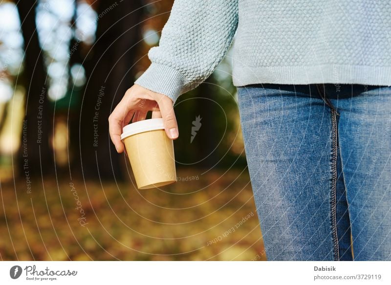 woman hold cup of coffe takeaway in the autumn park coffee outdoor tea drink disposable female paper hand go hot morning latte holding leaves orange tree nature