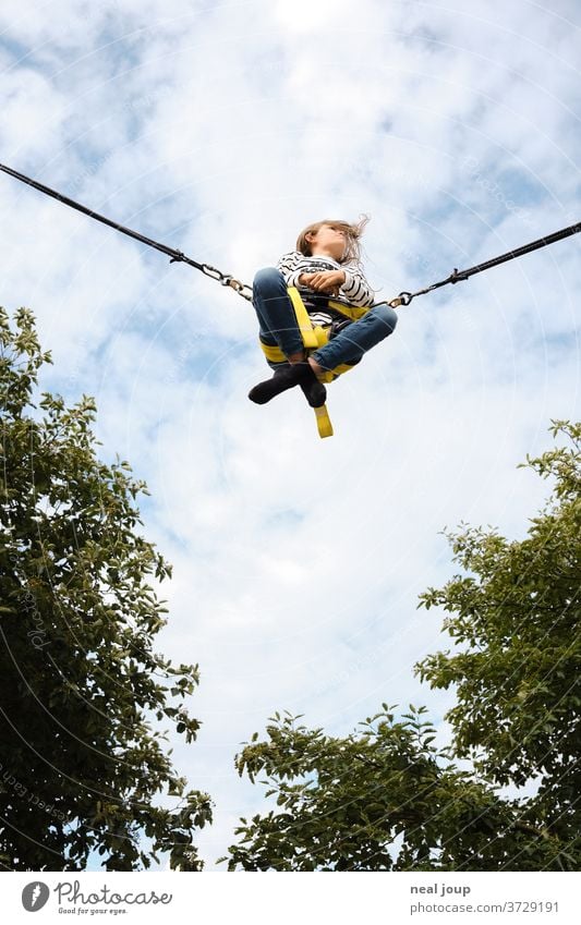 Girl flies in the sky - Rocket Bungee Flying cheerful Free Freedom Ease Easygoing Sit Cross Legged free time pleasure Exterior shot Sky Leisure and hobbies