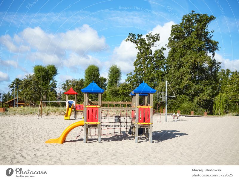 Empty outdoor playground on a beach on a sunny day. sand childhood slide fun game nature park recreation safe daycare education outside recreation ground youth