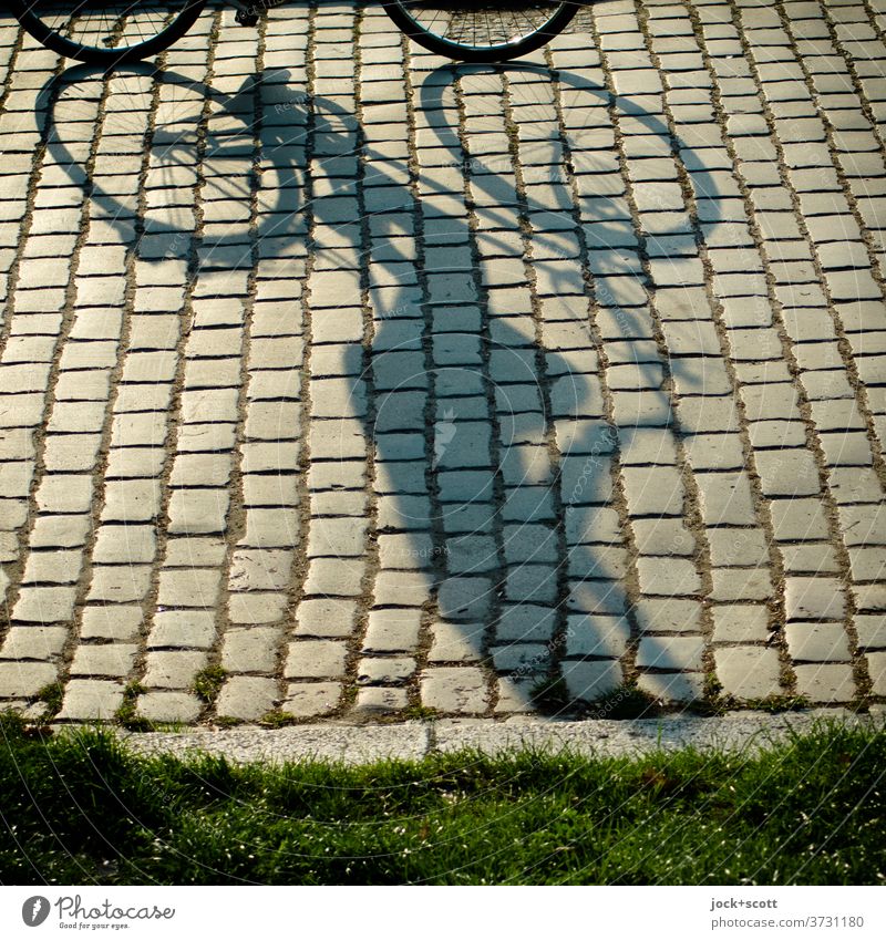 Sunshine on the way by bike Cycling Summer Lanes & trails Cobblestones Prenzlauer Berg Moody Long Human being Serene Mobility Perspective Shadow play Silhouette