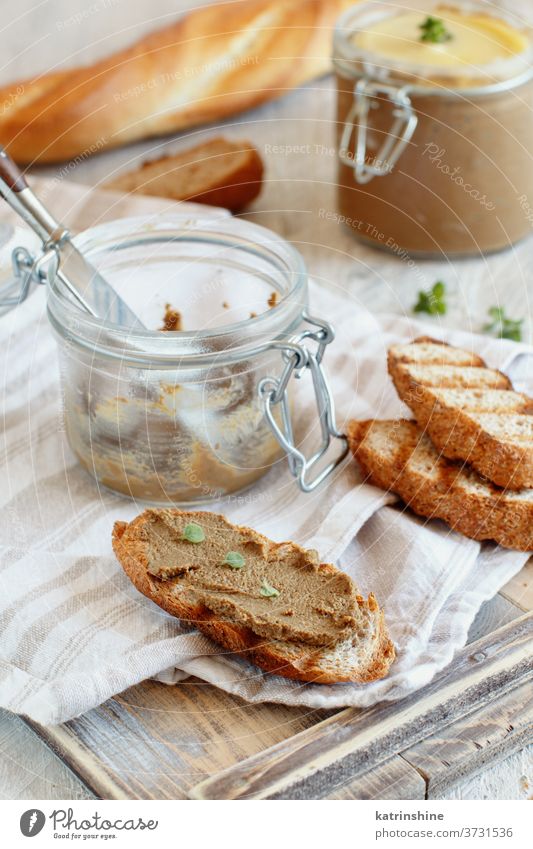Making sandwiches with homemade pate Baguette Pate Close up Toast Herb Jar Wooden Homemade Liver Rustic Mousse Thyme Goose Table Toasted Healthy Knife Gourmet