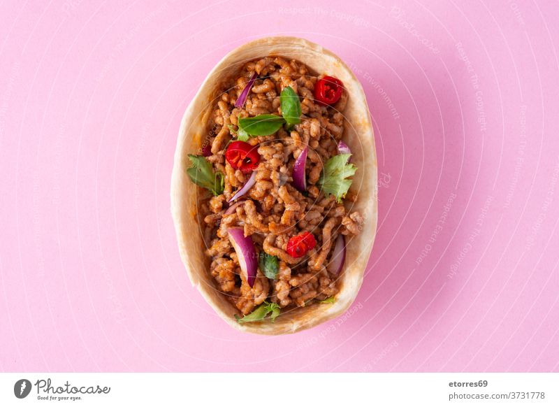 Mexican barquita taco with beef and vegetables on pink background mexican food chilli red spices meat chicken tortilla corn onion delicious traditional dinner