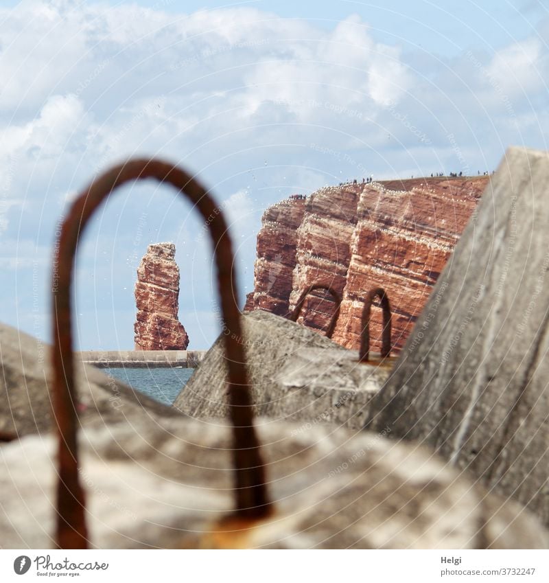 Lange Anna - View through the metal eyelet of a tetrapod to the red rock of Helgoland Tall Anna Red rock tetrapods Concrete Metal Vista Landscape Nature