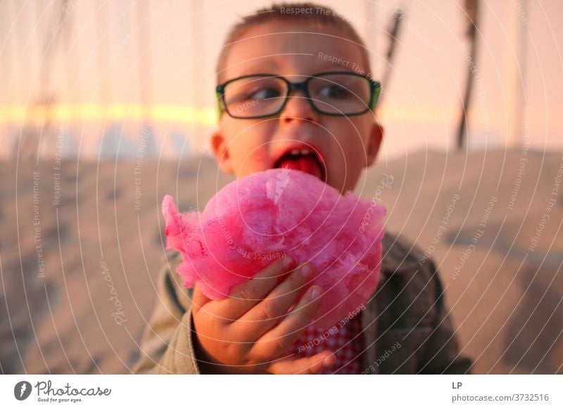 boy eating pink candy floss Boy (child) Looking Front view Upper body Portrait photograph Sunlight Exterior shot Multicoloured Innocent Reluctance Survive