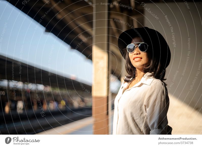 Black hat woman at train platform. person travel people vacation lifestyle holiday women tourism girl tourist summer trip destination traveller happy female