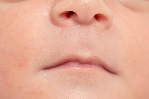 Closeup shot of a newborn baby lip and nose- peacefully slept in bed boy sleep infant cute care skin detail health close-up child soft beautiful blanket hair