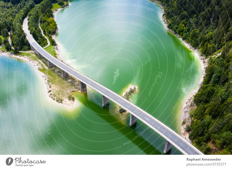 Aerial view of Bridge over Sylvenstein Lake aerial alps bank beach beautiful blue bridge causeway clouds cloudy dam day europe forest green hiking isar lake