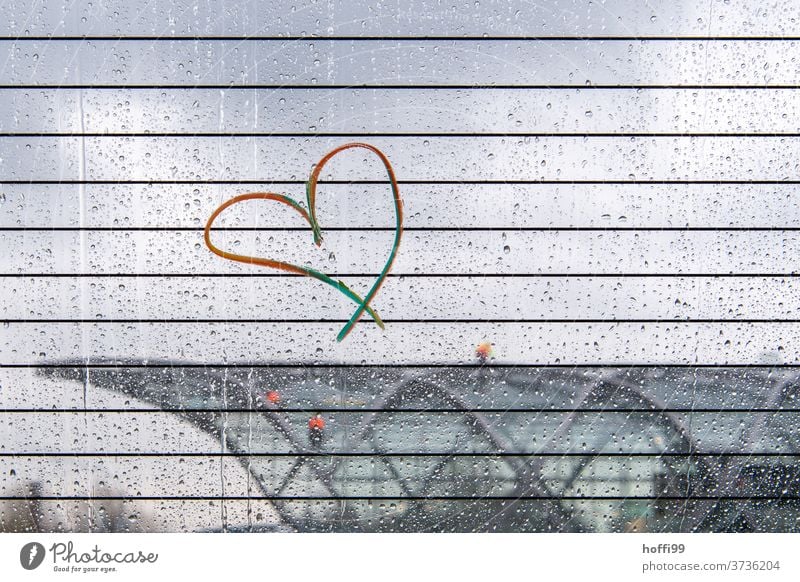 Rainbow heart on a rainy disc with a blurred view of the modern architecture of an S-Bahn station Prismatic colors Heart Heart-shaped Infatuation