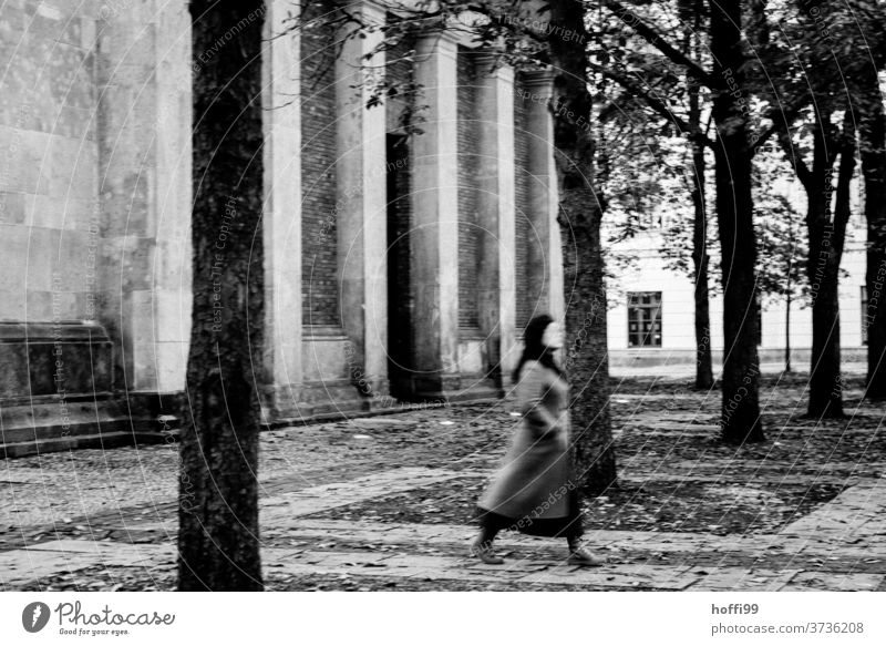 A passer-by hurriedly crosses the autumnal square in front of the new Berlin police station New Guard House Places Autumnal somber Occur Movement Motion blur