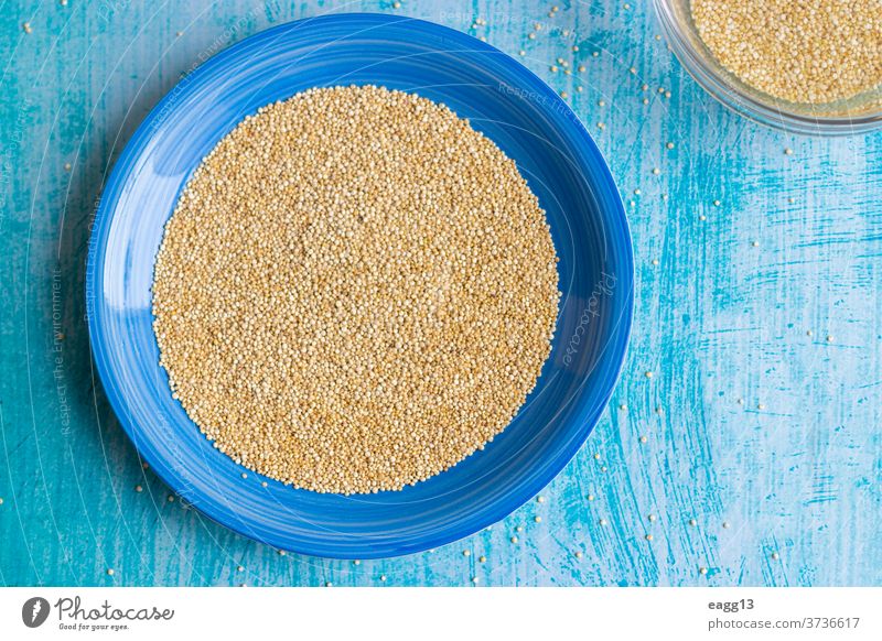 Uncooked quinoa grains inside blue plate Preparation background beans beige bowl composition cuisine culinary decorate diet dietary fiber flowers food foods