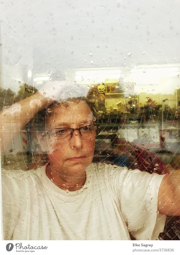 Thoughtfully, she looks out into the rain... Woman Human being Face sad look Meditative Window pane Rain
