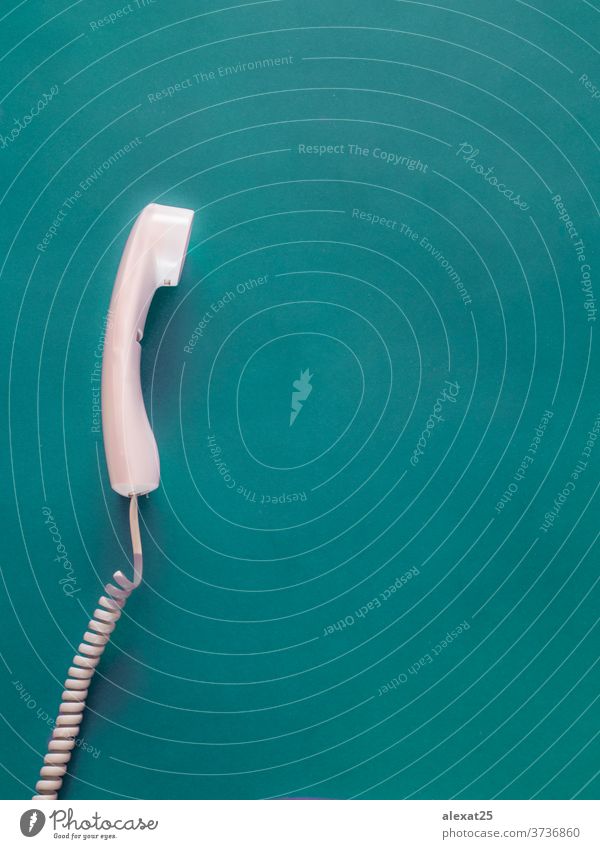 Telephone handset on green background with copy space business cable call classic communicate communication concept connection contact equipment line nobody