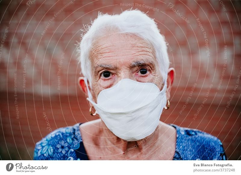 portrait of old lady wearing protective mask. new normal corona virus elder 80s grandmother woman elderly home white hair grey hair mental aged health care