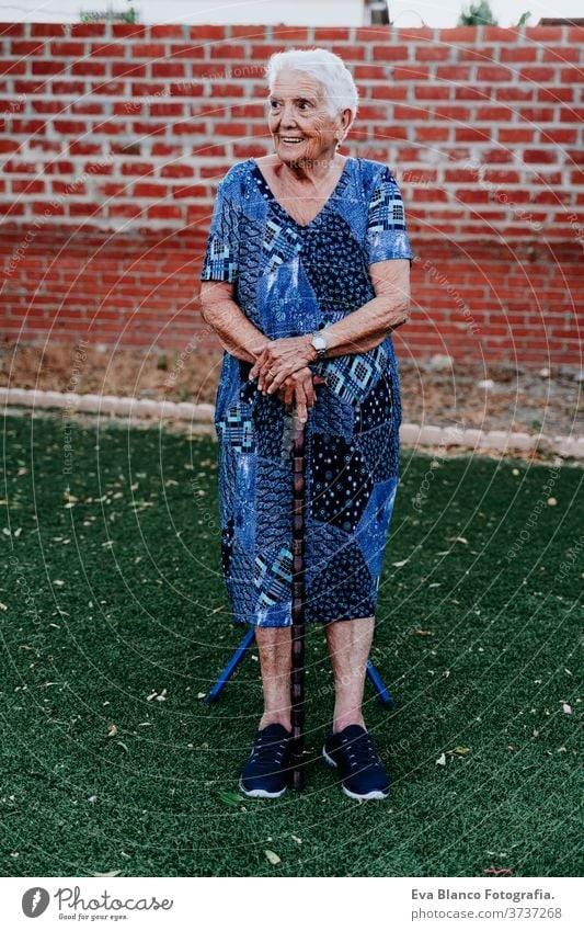 portrait of old lady in her 80s relaxed outdoors woman elderly home garrotte white hair grey hair mental solitude thoughtful grandmother aged health care