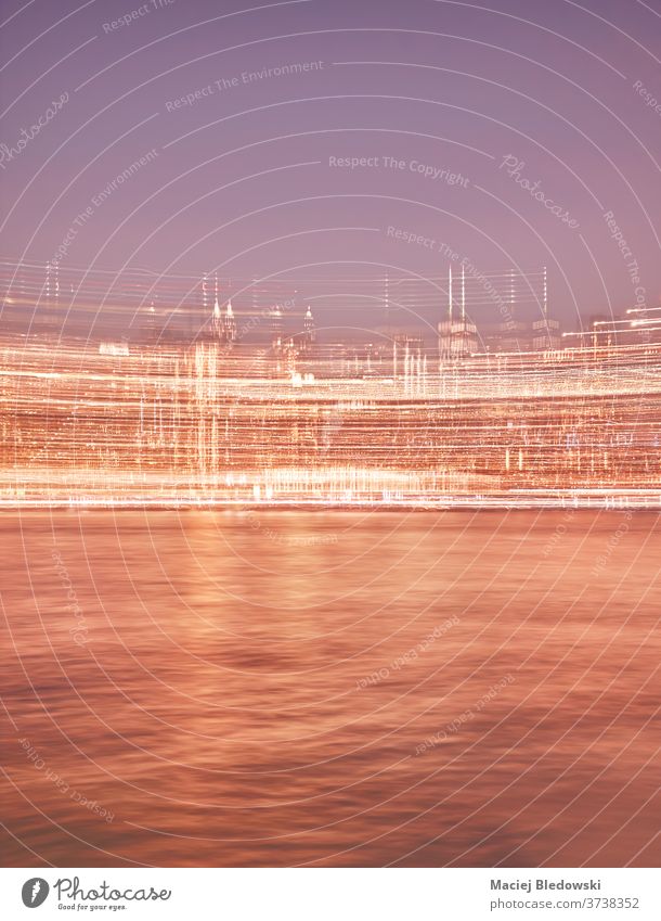 Motion blurred picture of Manhattan skyline at night. city New York motion blurred abstract defocused cityscape travel filtered USA urban river water waterfront