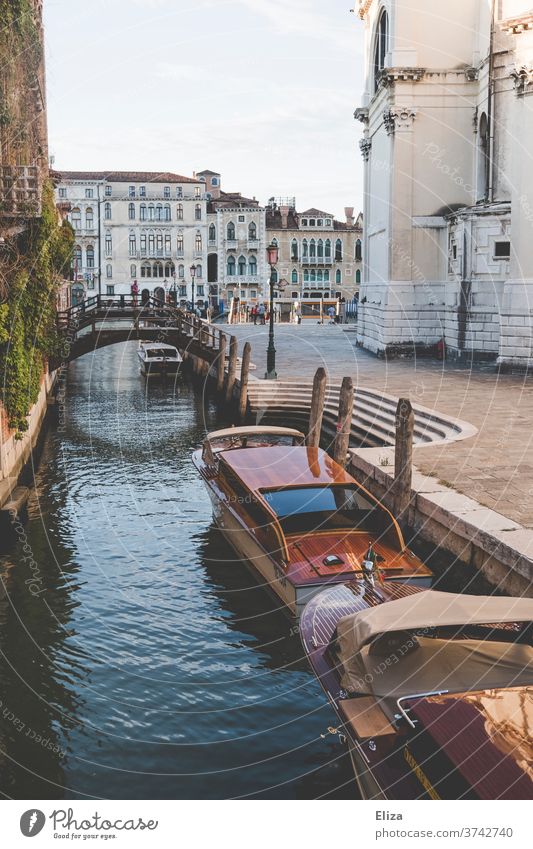 A canal with boats and a bridge in Venice Channel Town Old town Italy Water Watercraft Port City Tourist Attraction