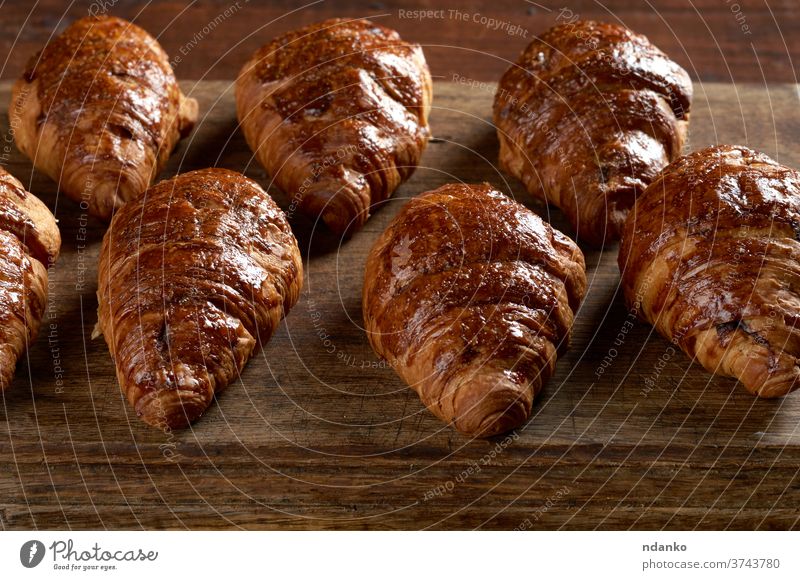 baked croissants on a wooden brown board, delicious and appetizing pastries crust cuisine dessert dough food french fresh golden homemade meal morning nutrition