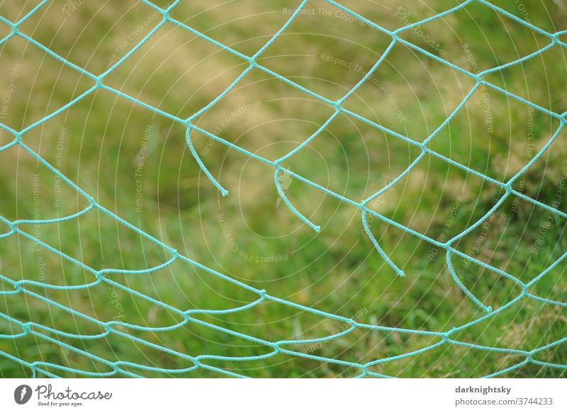 Detail of a net from a football goal with a long crack Net weave broken Crack & Rip & Tear Nature Grass Environment Colour photo Exterior shot Deserted green