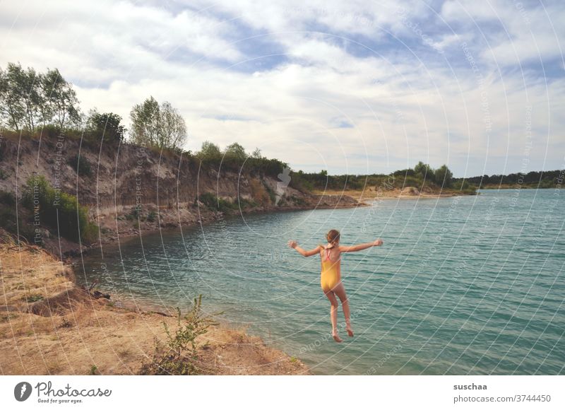 girls at a turquoise quarry pond Child Lake Swimming lake Lake Baggersee Summer Summer vacation holidays stay at home bathe Jump Hop jump Water Wet Infancy