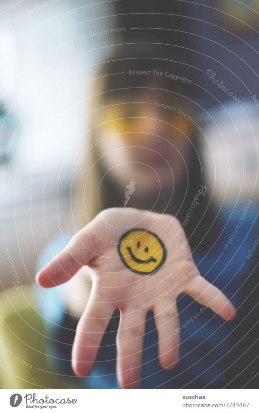 teenager with painted smiley face on hand Smiley Emotiocon emoji Sign Face Happiness Laughter Emotions Funny Joie de vivre (Vitality) Optimism Moody Contentment